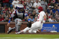 St. Louis Cardinals' Paul Goldschmidt, right, scores past New York Mets catcher Tomas Nido during the sixth inning of a baseball game Monday, May 6, 2024, in St. Louis. (AP Photo/Jeff Roberson)