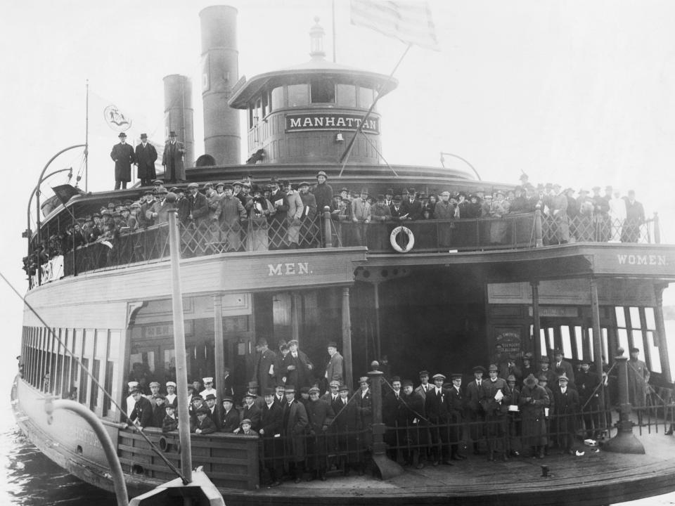 A black and white photo of the ferry filled with passengers