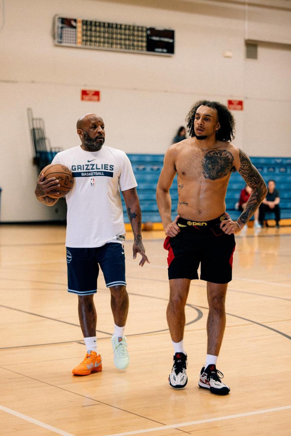 Devin Carter (right) working out with his father, former Miami Heat guard and assistant coach Anthony Carter (left).