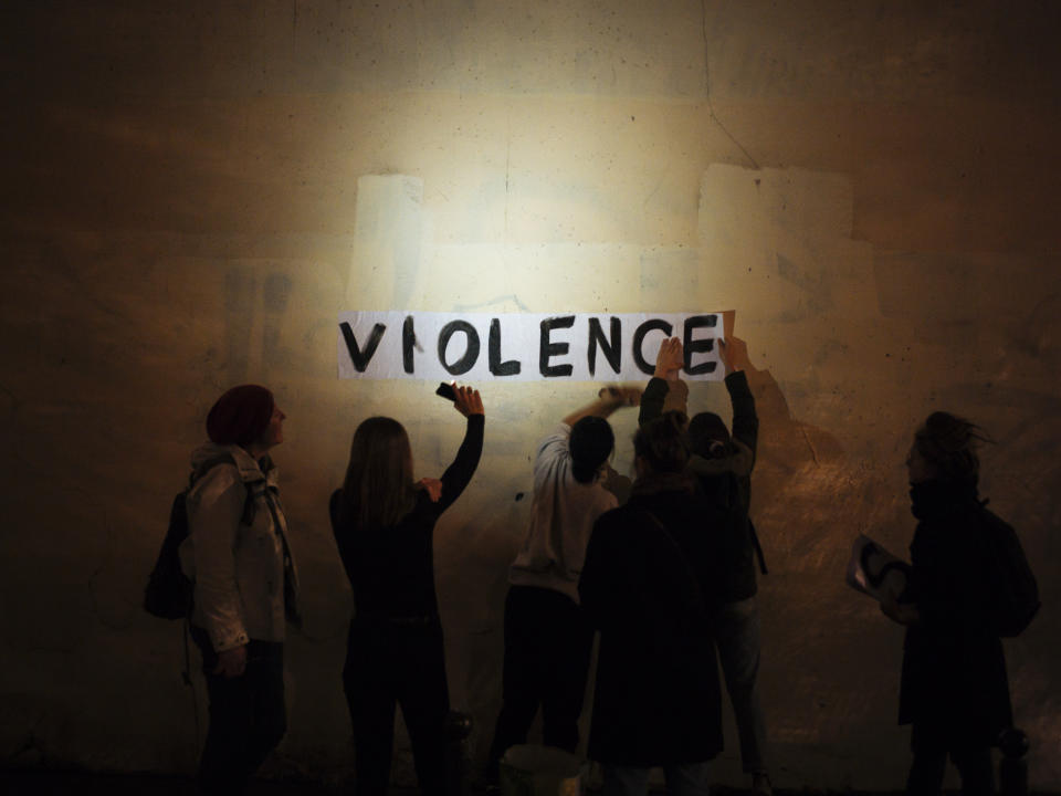 The word "violence" is pasted onto a wall by a group of women in a dark street in Paris. In Paris and cities across France, the signs are everywhere. "Complaints ignored, women killed" and "She leaves him, he kills her," they read in black block letters pasted over stately municipal buildings. Under cover of night, activists have glued them to the walls to draw attention to domestic violence, a problem French President Emmanuel Macron has called "France's shame." (Photo: Kamil Zihnioglu/AP)