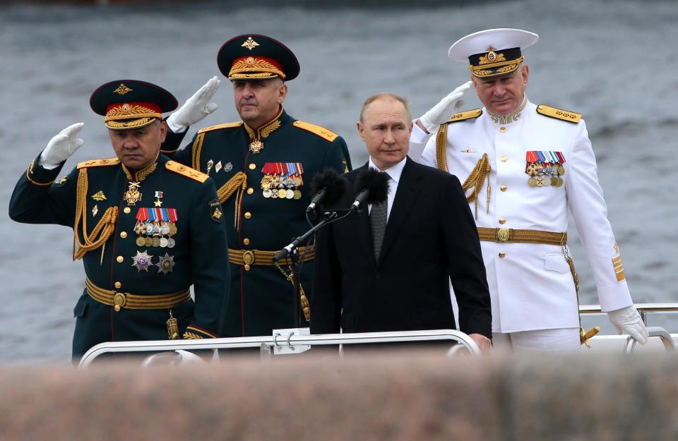 ) Russian President Vladimir Putin (C), Defense Minister Sergei Shoigu (L) and Chief Commander of the Russia Fleet Nikolai Yevmenov (R) seen aboard of the boat during the Navy Day Parade, on July, 31 2022, in Saint Petersburg, Russia. President Vladimir Putin has arrived to Saint Petersburg to review Main Naval Parade involving over 50 military ships on Russia's Navy Day.