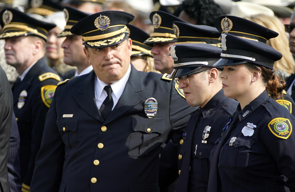 Houston Police Chief Art Acevedo, left, comforts an officer as the casket carrying Houston police Sgt. Christopher Brewster is moved during a funeral service, Thursday, Dec. 12, 2019, at Grace Church Houston in Houston. Brewster, 32, was gunned down Saturday evening, Dec. 7, while responding to a domestic violence call in Magnolia Park. Police arrested 25-year-old Arturo Solis that night in the shooting death. Solis faces capital murder charges. (AP Photo/David J. Phillip)