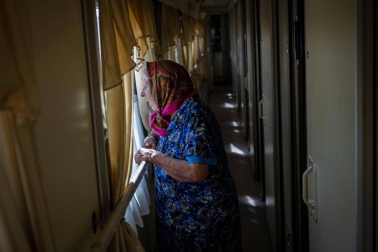 An elderly woman who has been evacuated from the Lysychansk area look out the window of an evacuation train in Pokrovsk in eastern Ukraine, Friday, June 10, 2022. 