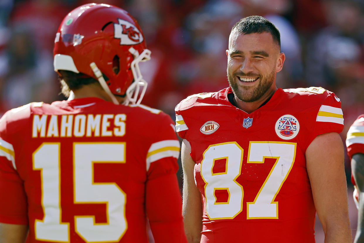 KANSAS CITY, MISSOURI - OCTOBER 22: Travis Kelce #87 and Patrick Mahomes #15 of the Kansas City Chiefs talk before the game against the Los Angeles Chargers at GEHA Field at Arrowhead Stadium on October 22, 2023 in Kansas City, Missouri. (Photo by David Eulitt/Getty Images)