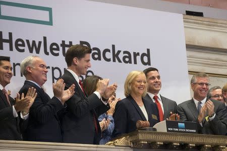 Meg Whitman, (C) Chief Executive Officer of Hewlett-Packard, and company executives ring the opening bell at the New York Stock Exchange to celebrate the start of trading of Hewlett Packard Enterprise Co., November 2, 2015. Shares of HP Inc., the legacy printer and PC business of the former Hewlett-Packard Co, soared as much as 11 percent in early trading on Monday, outpacing those of Hewlett Packard Enterprise Co, the new company that holds the tech pioneer's corporate hardware and services division. REUTERS/Brendan McDermid