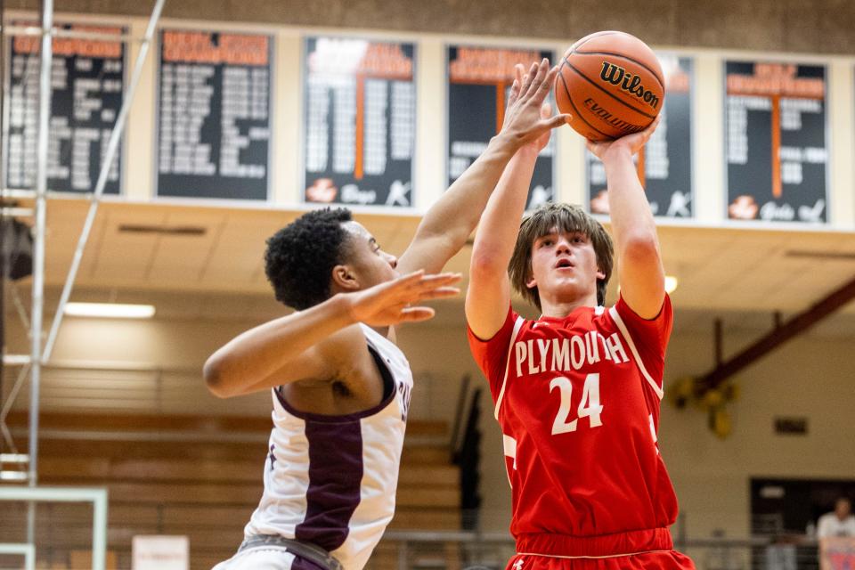 Plymouth's Davis Wray (24) shoots the ball as Mishawaka's Rasauun Johnson (13) defends during the Plymouth-Mishawaka high school 4A sectional basketball game on Tuesday, February 28, 2023, at LaPorte High School in LaPorte, Indiana.