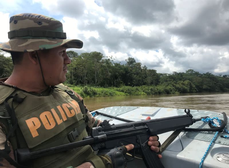 Peruvian anti-narcotics police officer patrols the Amazon river in Caballococha