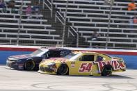 Justin Allgaier, left, and Kyle Busch (54) race down the front stretch late in a NASCAR Xfinity Series auto race at Texas Motor Speedway in Fort Worth, Texas, Saturday, June 12, 2021. (AP Photo/Larry Papke)