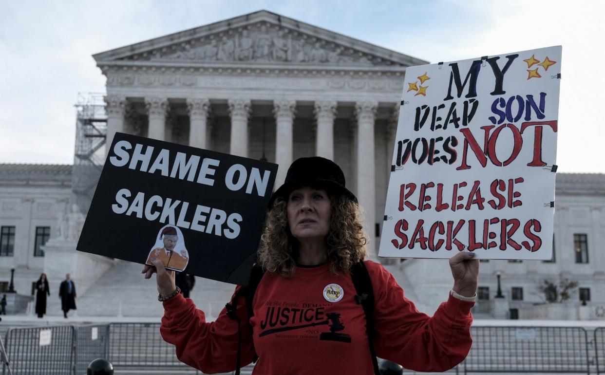 Grace Bisch, whose stepson died as a result of an overdose, protests outside the Supreme Court in December 2023. <a href="https://www.gettyimages.com/detail/news-photo/grace-bisch-hold-a-picture-of-stepson-eddie-bisch-who-died-news-photo/1824554775?searchscope=image%2Cfilm&adppopup=true" rel="nofollow noopener" target="_blank" data-ylk="slk:Michael A. McCoy/The Washington Post via Getty Images;elm:context_link;itc:0;sec:content-canvas" class="link ">Michael A. McCoy/The Washington Post via Getty Images</a>