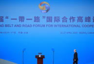 Russian President Vladimir Putin walks on stage to deliver his speech at the opening ceremony of the second Belt and Road Forum for International Cooperation (BRF) in Beijing Friday, April 26, 2019. (How Hwee Young/Pool Photo via AP)