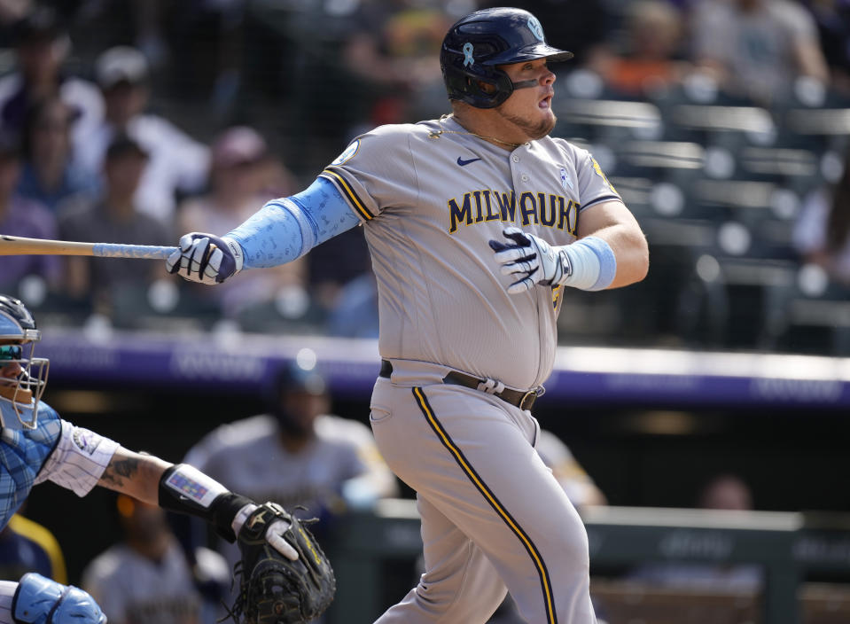 Milwaukee Brewers' Daniel Vogelbach connects for an RBI-single off Colorado Rockies relief pitcher Daniel Bard in the ninth inning of a baseball game Sunday, June 20, 2021, in Denver. The Brewers won 7-6. (AP Photo/David Zalubowski)