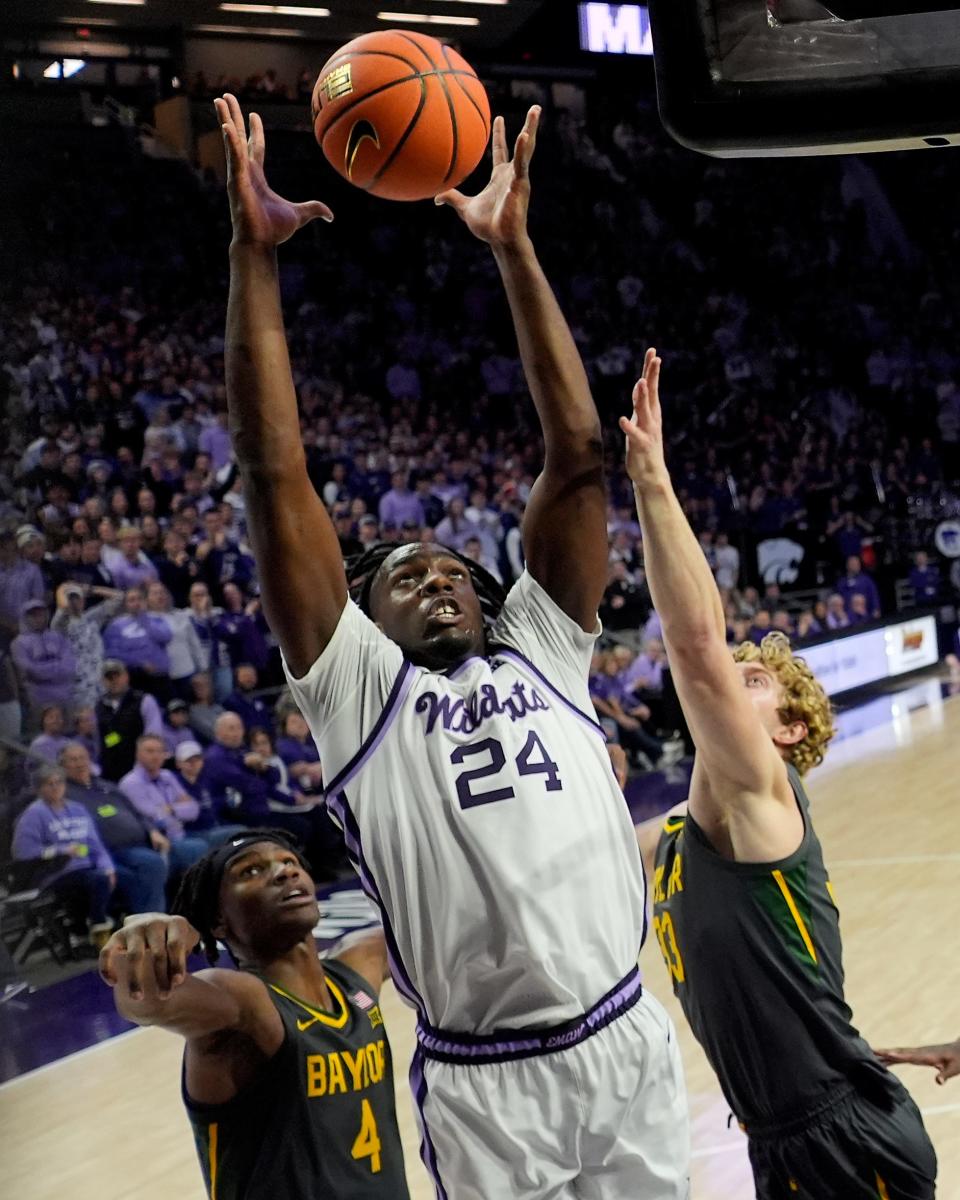 Kansas State forward Arthur Kaluma (24) beats Baylor guard Ja'Kobe Walter (4) and forward Caleb Lohner (33) to a rebound during the first half of an NCAA college basketball game Tuesday, Jan. 16, 2024, in Manhattan, Kan. (AP Photo/Charlie Riedel)