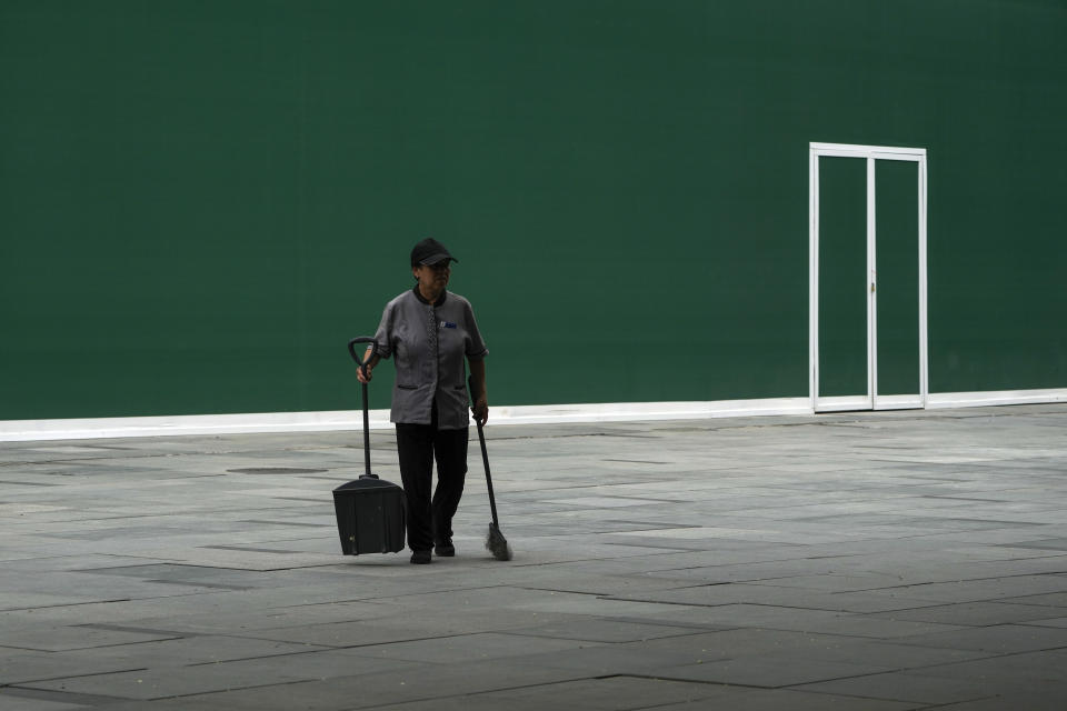 A cleaner walks by a vacant shop at an outdoor shopping mall in Beijing on Thursday, July 27, 2023. Chinese leader Xi Jinping’s government is promising to drag the economy out of a crisis of confidence aggravated by tensions with Washington, wilting exports, job losses and anxiety among foreign companies about an expanded anti-spying law. (AP Photo/Andy Wong)