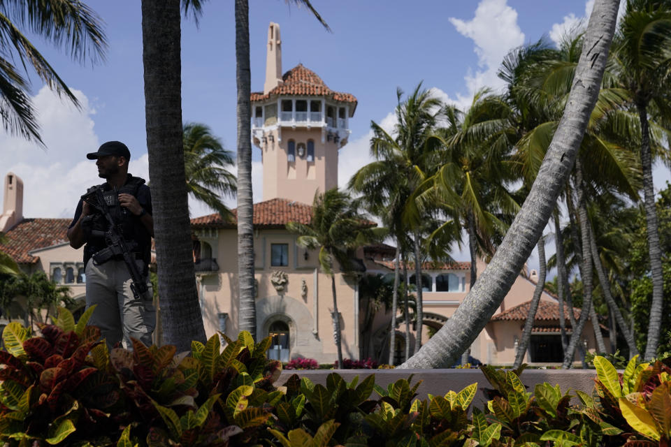 FILE - A security guard stands on the perimeter of former President Donald Trump's Mar-a-Lago home, Monday, April 3, 2023, in Palm Beach, Fla., a day before he travels to New York for his arraignment on charges related to hush money payments. Within days, Trump could potentially have his sprawling real estate business empire ordered “dissolved” for repeated misrepresentations on financial statements to lenders, adding him to a short list of scam marketers, con artists and others who have been hit with the ultimate punishment for violating New York’s powerful anti-fraud law. (AP Photo/Evan Vucci, File)