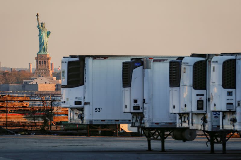 FILE PHOTO: Refrigerated tractor trailers used to store bodies of deceased people are seen at a temporary morgue in Brooklyn, New York