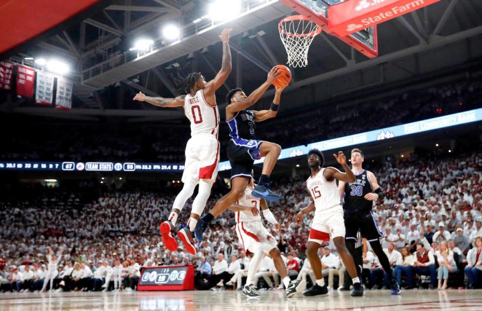 Duke’s Jeremy Roach (3) heads to the basket while defended by Arkansas’ Khalif Battle (0) during Arkansas’ 80-75 victory over Duke at Bud Walton Arena in Fayetteville, Ark., Weds. Nov. 29, 2023.