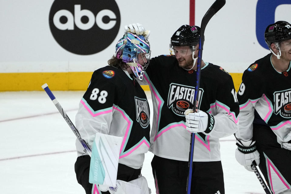 Atlantic Division's Andrei Vasilevskiy of the Tampa Bay Lightning (88) and Aleksander Barkov, of the Florida Panthers (16) celebrate after winning the NHL All Star hockey game, Saturday, Feb. 4, 2023, in Sunrise, Fla. (AP Photo/Marta Lavandier)