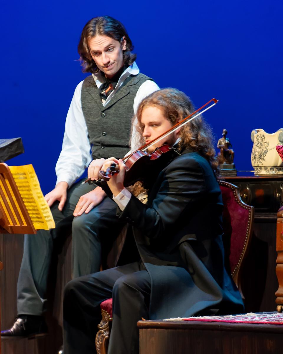 Sheridan McMichael, left, who plays Iosif Kotek, watches violinist Samuel Gilles play during a performance of Lyric Theatre's world-premiere production of "Concerto," a fact-based play by Alan Olejniczak.