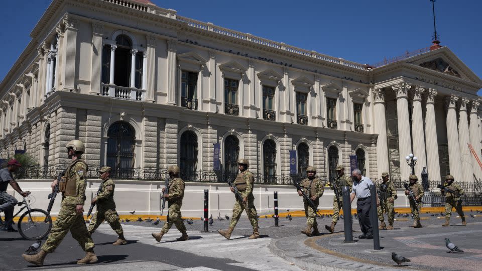 Soldiers patrol in front of the National Palace building at the Barrios square in the historic center of San Salvador on January 31, 2024. - Yuri Cortez/AFP/Getty Images