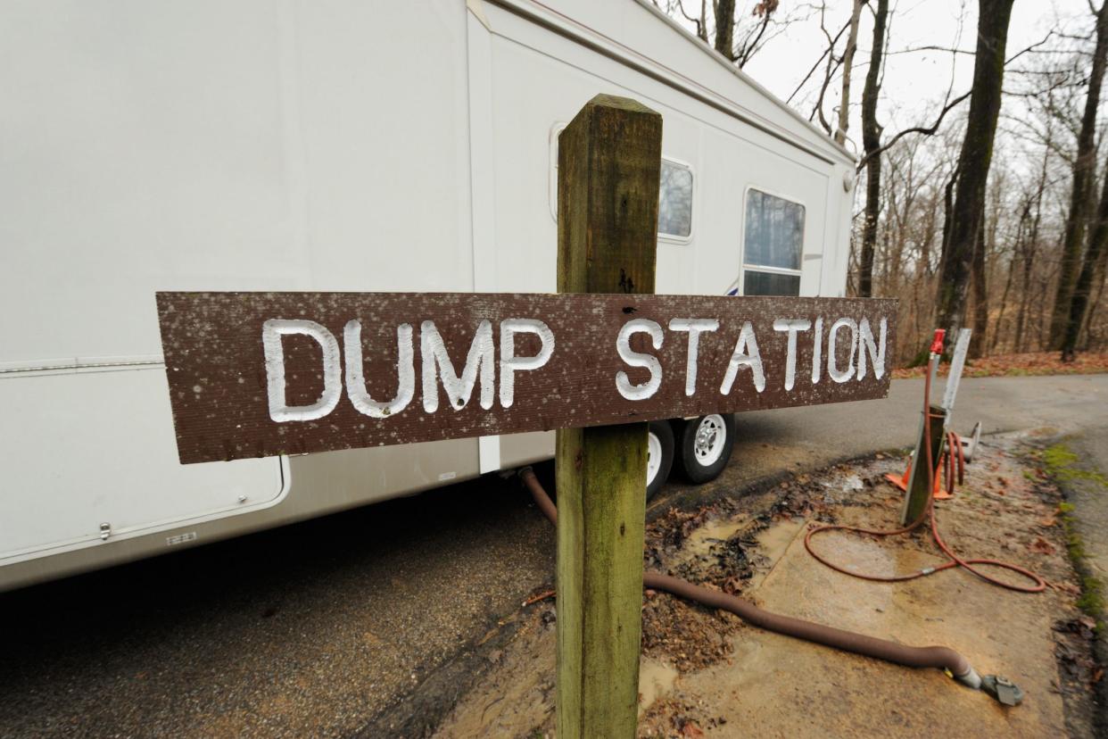 rv with hose at dump station