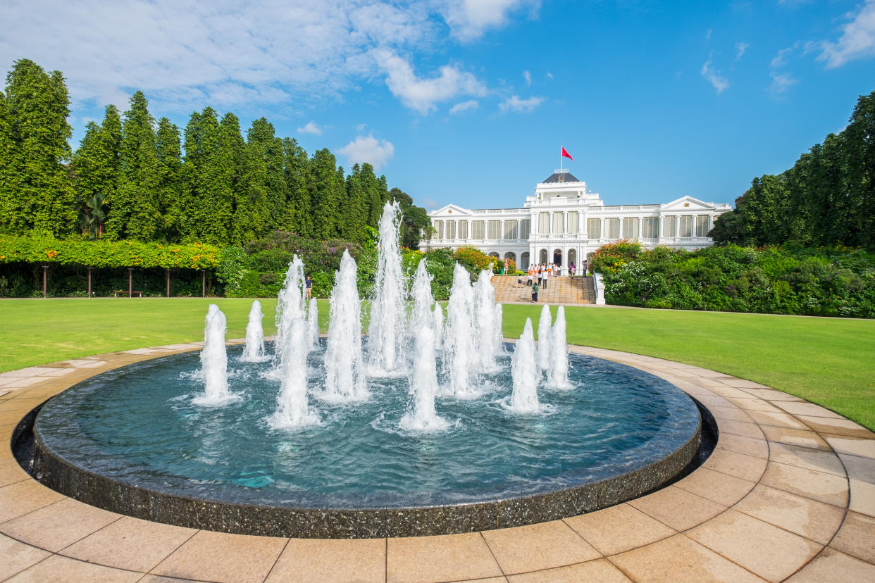 Singapore's The Istana main building with a fountain in the foreground.