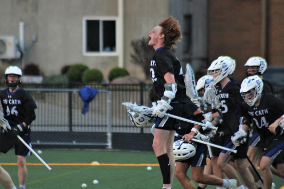 Covington Catholic senior Luke Stetter and teammates celebrate his game-winning goal in sudden-death overtime as Covington Catholic defeated Walton-Verona 10-9 in overtime in high school boys lacrosse April 27, 2022, at Covington Catholic High School.