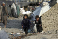 Internally displaced girls play outside their temporary home in the city of Kabul, Afghanistan, Monday, Jan. 18, 2021. Half of war-ravaged Afghanistan’s population is at risk of not having enough food to eat, including around 10 million children, Save the Children, a humanitarian organization said Tuesday. The group called for $3 billion in donations to pay for assistance in 2021. (AP Photo/Rahmat Gul)