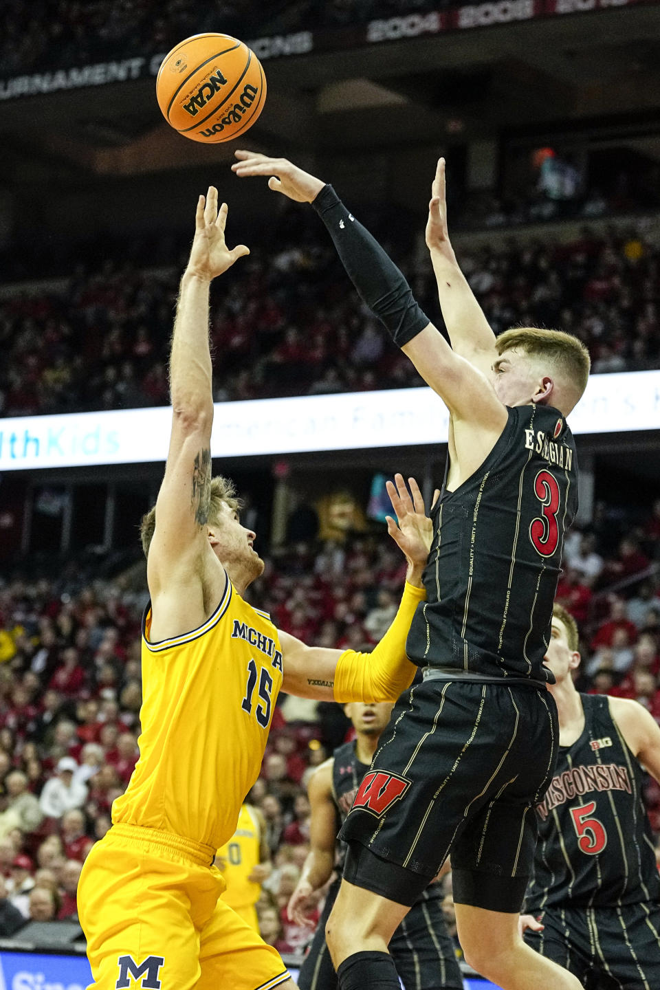 Wisconsin's Connor Essegian (3) blocks Michigan's Joey Baker (15) during the first half of an NCAA college basketball game Tuesday, Feb. 14, 2023, in Madison, Wis. (AP Photo/Andy Manis)