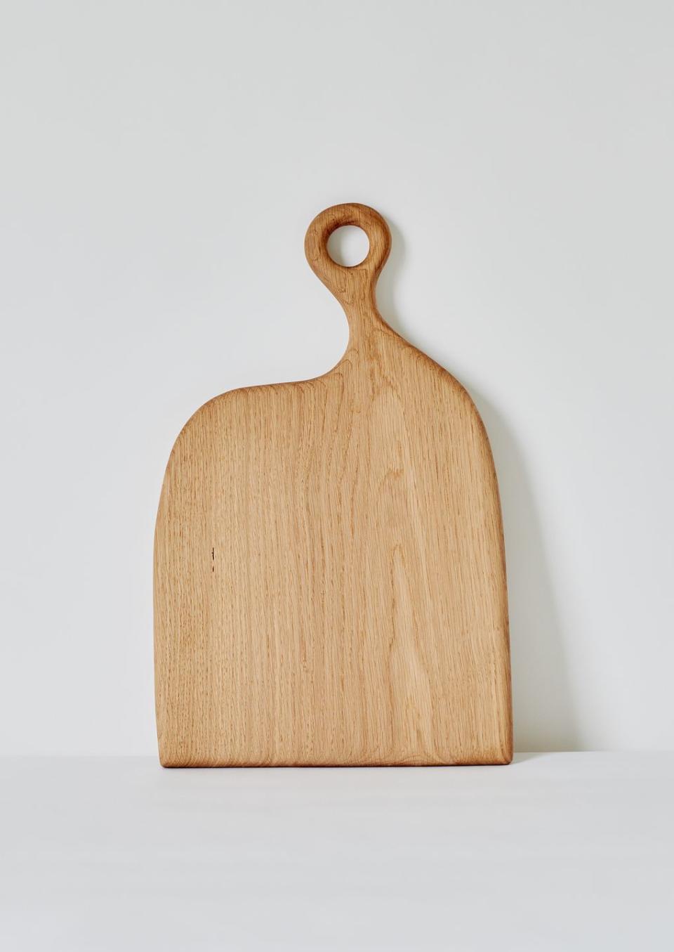 <p>West Sussex crafters Forge Creative lend their fine furniture skills to a range of perfectly formed objects. Their characterful chopping boards are made from locally sourced oak, which is shaped into a loop at one end for hanging in the kitchen. £65, <a href="https://www.toa.st/products/forge-creative-long-oak-chopping-board-natural" rel="nofollow noopener" target="_blank" data-ylk="slk:To.ast;elm:context_link;itc:0;sec:content-canvas" class="link ">To.ast</a></p>