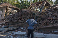 <p>A man inspects the ruins of houses at a village affected by Sunday’s earthquake in Kayangan, Lombok Island, Indonesia, Tuesday, Aug. 7, 2018. (Photo: Fauzy Chaniago/AP) </p>
