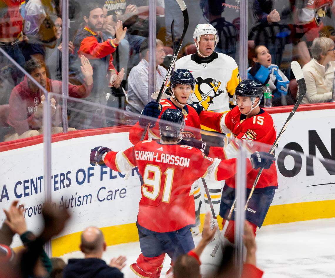 Florida Panthers center Eetu Luostarinen (27) celebrates with his teammates after scoring a goal against the Pittsburgh Penguins in the third period of their NHL game at the Amerant Bank Arena on Friday, Dec. 8, 2023, in Sunrise, Fla. MATIAS J. OCNER/mocner@miamiherald.com