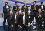 Retired Vancouver Canucks players. twins Daniel, front left, and Henrik Sedin, prepare to speak during a jersey retirement ceremony before an NHL hockey game between the Canucks and the Chicago Blackhawks in Vancouver, British Columbia, Wednesday Feb. 12, 2020. (Darryl Dyck/The Canadian Press via AP)