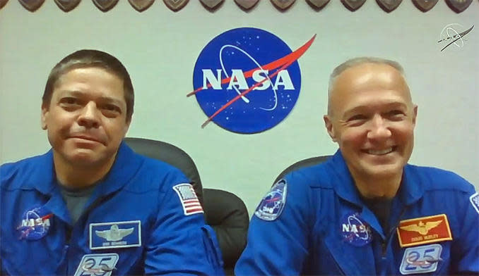 Robert Behnken, left, and Crew Dragon commander Douglas Hurley field questions phoned in from reporters Friday during a virtual news conference at the Kennedy Space Center  / Credit: NASA