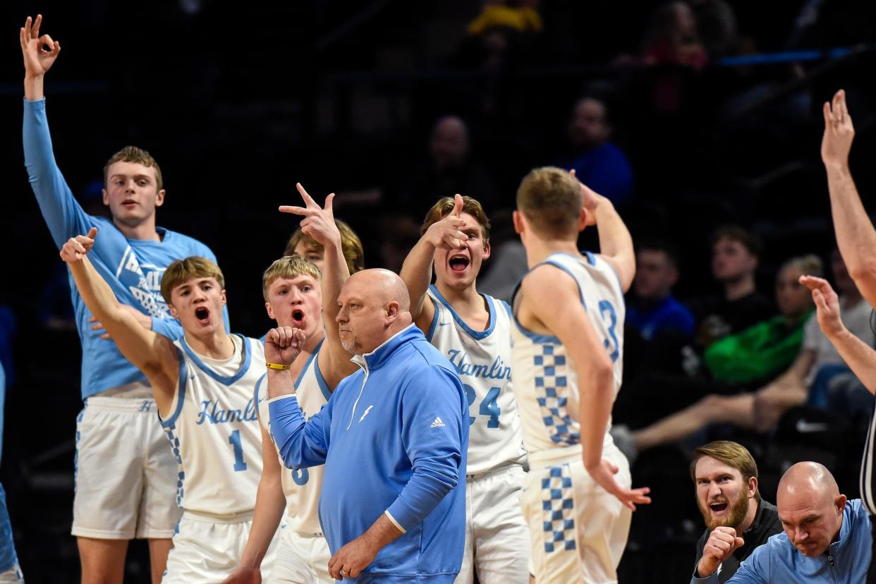 Hamlin head coach Todd Neuendorf and the bench celebrate a 3-point basket during a semifinal game against Rapid City Christian in the state Class A boys basketball tournament on Friday, March 15, 2024 in the Summit Arena at The Monument in Rapid City. Hamlin won 62-45.