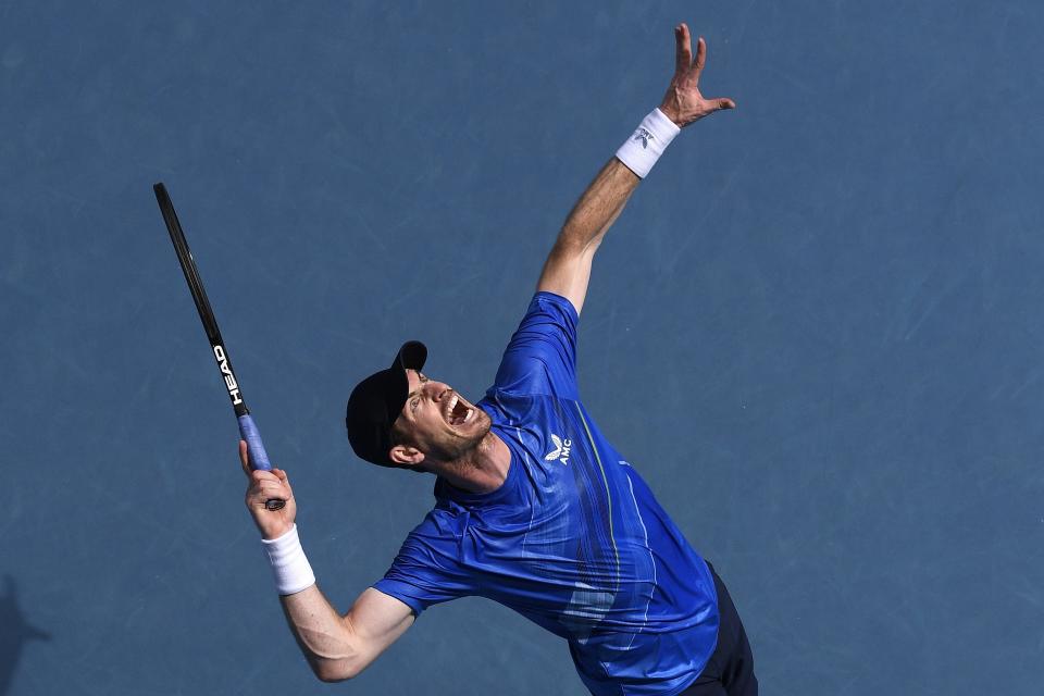 Andy Murray of Britain serves to Nikoloz Basilashvili of Georgia during their first round match at the Australian Open tennis championships in Melbourne, Australia, Tuesday, Jan. 18, 2022. (AP Photo/Andy Brownbill)