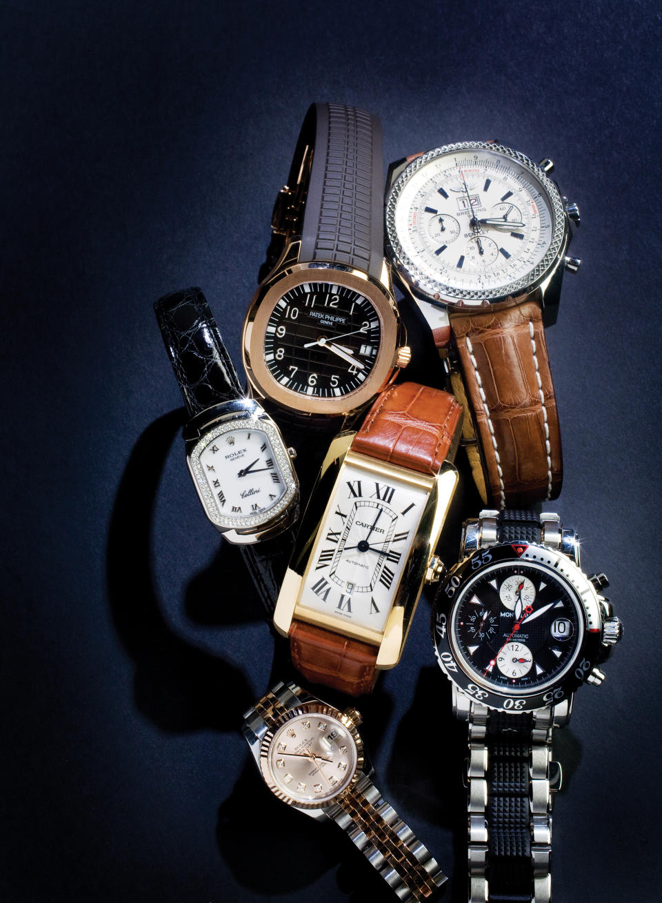 At top left, Patek Philippe's rose-gold Aquanaut timepiece with a chocolate brown dial and strap ($28,300) angles into a classic gold Cartier tank ($6,775). At top right, a Breitling "Bentley" automatic chronograph ($5,499) bears a distinctive bezel and band, as does the Mont Blanc dive watch ($3,705) at bottom right. For her, Rolex is second to none, whether it's the diamond-accented Cellini ($16,750) at left or the rose-gold Date just with a pink dial below ($6,999).  (Photo by Ross Hailey/Fort Worth Star-Telegram/Tribune News Service via Getty Images)