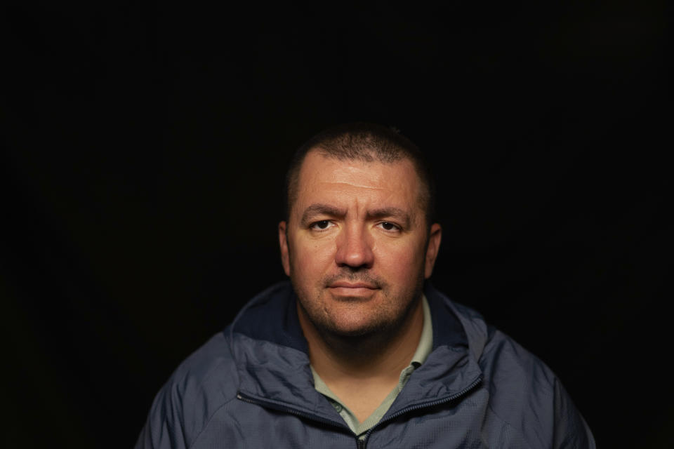 Volodymyr Rykun sits for a portrait in Zaporizhzhia, Ukraine, Friday, May 26, 2023. Rykun, from the occupied town of Mykhailivka, was head of the city council. He was taken from his office on April 6, 2022, and refused orders to change the flag from Ukrainian to Russian. A few days later, he was taken at gunpoint to resign, said he was tortured with electricity, and listened as a colleague was tortured as well. He said his tormentors played music as they inflicted pain upon their victims, but it wasn’t enough to cover the cries. He was released after 18 days and he and his wife escaped the occupied regions. (AP Photo/Evgeniy Maloletka)