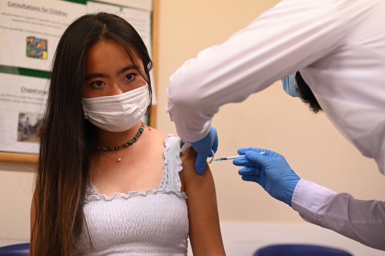 A student is given a dose of the Pfizer/BioNTech vaccine at a health centre in London (AFP via Getty Images)