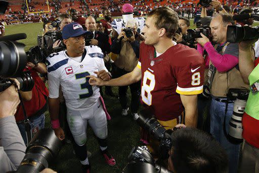 Seattle Seahawks quarterback Russell Wilson (3) and Washington Redskins quarterback Kirk Cousins (8) talk after an NFL football game in Landover, Md., Monday, Oct. 6, 2014. Seattle defeated Washington 27-17. (AP Photo/Alex Brandon)