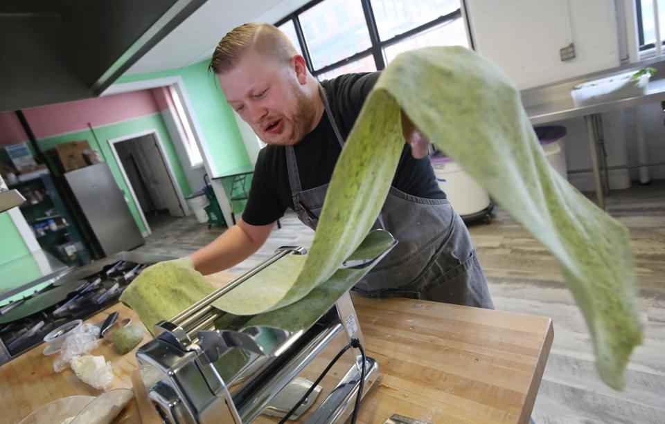 Michael Oldfield presses out a long sheet of ramp pasta, getting it to the desired thinness, as he makes homemade cappelletti at M.O. Pasta in the Hungerford Building in Rochester Friday, May 6, 2022.