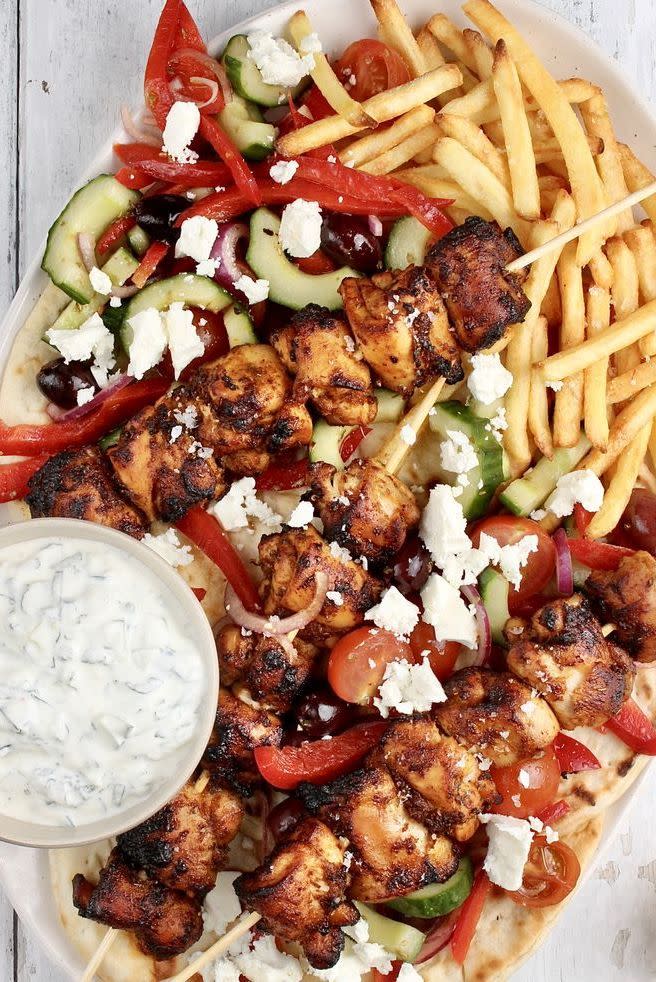 <p>Chicken souvlaki is a classic <a href="https://www.delish.com/uk/food-news/a30624859/greek-food/" rel="nofollow noopener" target="_blank" data-ylk="slk:Greek;elm:context_link;itc:0;sec:content-canvas" class="link ">Greek</a> fast food dish that will make you feel like you’re on holiday in no time. Consisting of grilled skewered pieces of meat, you eat it hot straight off the skewer and can serve it with a variety of sides - we've gone for flatbreads and chips, with <a href="https://www.delish.com/uk/cooking/recipes/a28839760/best-greek-salad-recipe/" rel="nofollow noopener" target="_blank" data-ylk="slk:Greek salad;elm:context_link;itc:0;sec:content-canvas" class="link ">Greek salad</a> and a good dollop of <a href="https://www.delish.com/uk/cooking/recipes/a30960236/authentic-tzatziki-recipe/" rel="nofollow noopener" target="_blank" data-ylk="slk:tzatziki;elm:context_link;itc:0;sec:content-canvas" class="link ">tzatziki</a>. </p><p>Get the <a href="https://www.delish.com/uk/cooking/recipes/a35901474/chicken-souvlaki/" rel="nofollow noopener" target="_blank" data-ylk="slk:Chicken Souvlaki;elm:context_link;itc:0;sec:content-canvas" class="link ">Chicken Souvlaki</a> recipe.</p>