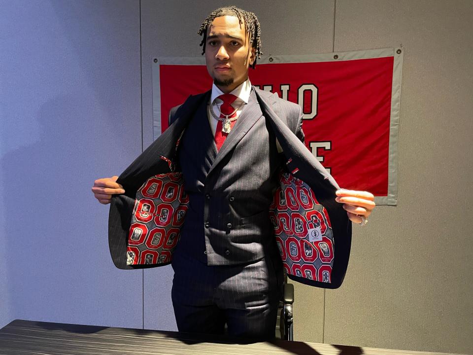Ohio State Buckeyes quarterback C.J. Stroud shows the jacket of his suit ahead of the Heisman Trophy ceremony on Saturday, Dec. 11, 2021.