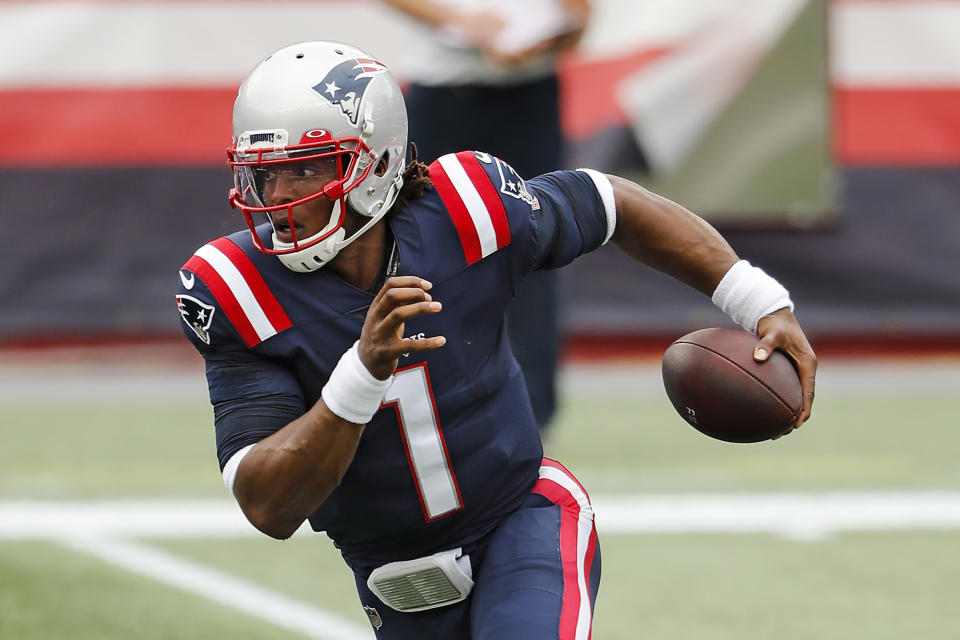 FILE - In this Sunday, Sept. 27, 2020, file photo, New England Patriots quarterback Cam Newton runs against the Las Vegas Raiders during an NFL football game at Gillette Stadium, in Foxborough, Mass. For the second straight week the New England Patriots are heading into a game after having their preparations disrupted by a teammate contracting coronavirus.  Last week it was Cam Newton, who tested positive two days before their matchup with Kansas City and was forced to sit out.(AP Photo/Winslow Townson, File)