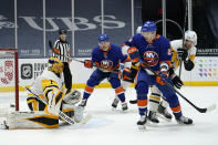 New York Islanders left wing Michael Dal Colle (28) and right-wing Oliver Wahlstrom (26) watch as Pittsburgh Penguins goaltender Casey DeSmith (1) deflects the puck during the second period of an NHL hockey game, Sunday, Feb. 28, 2021, in Uniondale, N.Y. (AP Photo/Kathy Willens)