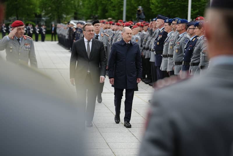 Germany's Chancellor Olaf Scholz (R) and Germany's Defence Minister Boris Pistorius review a military honour guard of the German armed forces (Bundeswehr) during a final ceremony in honour of soldiers deployed in Mali, in front of the German Ministry of Defence. Kay Nietfeld/dpa