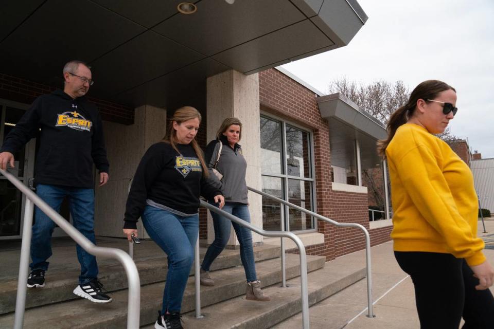 Parents and coaches with Esprit Metro Fastpitch Softball leave the Madison County Criminal Justice Center in Edwardsville on Friday after attending a hearing in which their former treasurer pleaded guilty to theft.