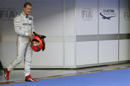 Mercedes Formula One driver Michael Schumacher of Germany walks in parc ferme after the qualifying session of the Malaysian F1 Grand Prix at Sepang International Circuit outside Kuala Lumpur in this March 24, 2012 file photo. REUTERS/Tim Chong/Files