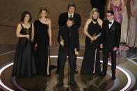 Raney Aronson-Rath, from left, Vasilisa Stepanenko, Mstyslav Chernov, Evgeniy Maloletka, Michelle Mizner, and Derl McCrudden accept the award for best documentary feature film for "20 Days in Mariupol" during the Oscars on Sunday, March 10, 2024, at the Dolby Theatre in Los Angeles. (AP Photo/Chris Pizzello)