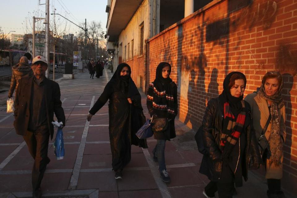 Pedestrians make their way on a sidewalk in a central square of Tehran, Iran, Monday, Jan. 30, 3017. Traditional American allies in the region have kept largely silent about President Donald Trump's executive actions to suspend issuing visas for people from several predominantly Muslim countries - Iran, Iraq, Libya, Somalia, Sudan, Syria and Yemen - for at least 30 days. Many welcome tougher action against Iran. (AP Photo/Vahid Salemi)