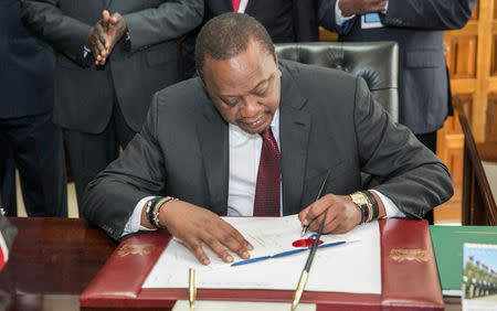 Kenya's President Uhuru Kenyatta signs a new finance bill into law at the State House in Nairobi, Kenya September 21, 2018. Presidential Press Service/Handout via REUTERS